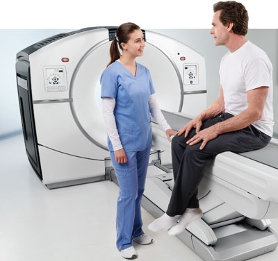 Technologist helping patient have PET Scan
