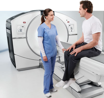Patient receiving PET/CT scan from doctor at medical imaging center in Kansas City specializing in PET/CT diagnostic imaging.